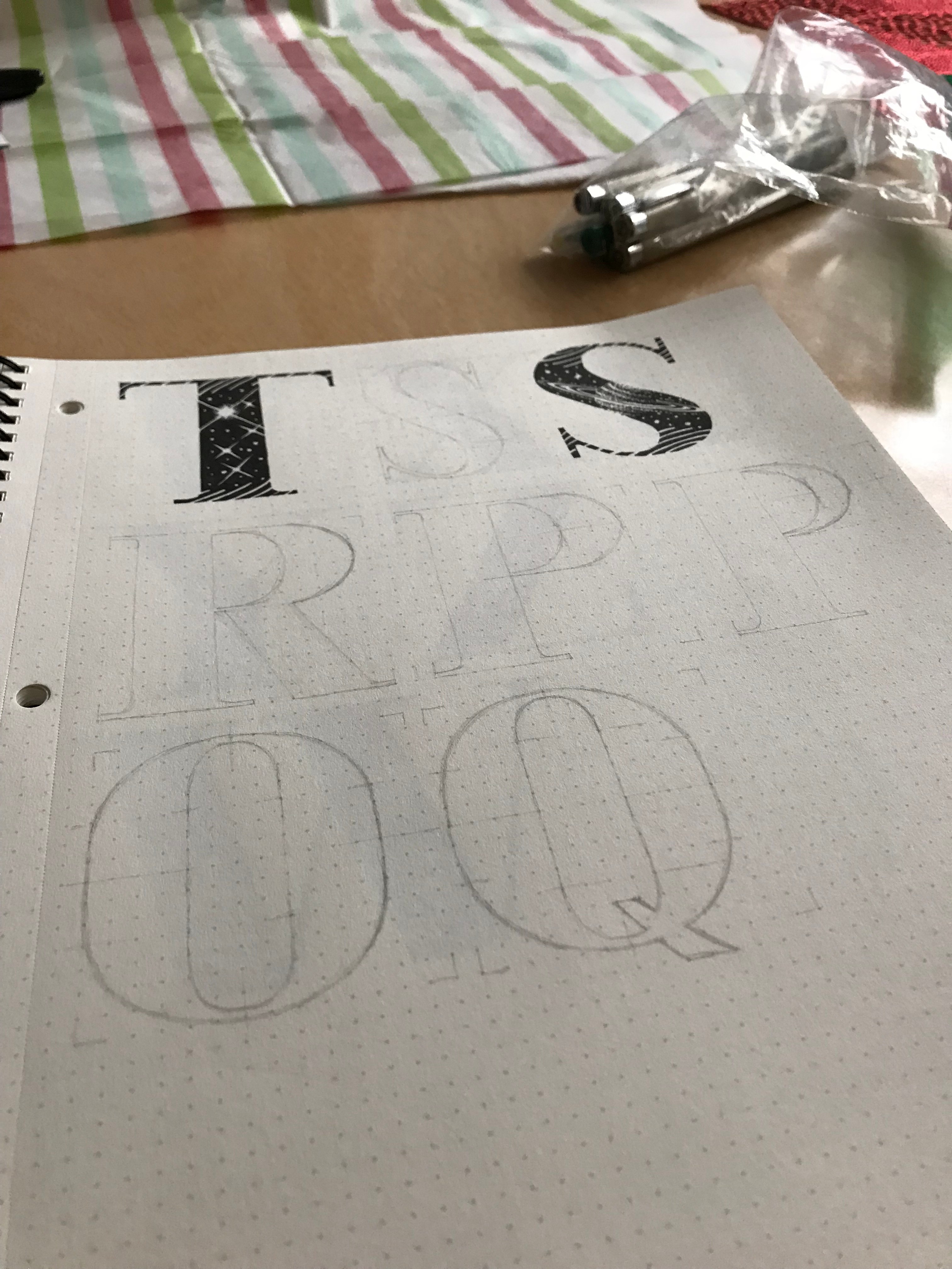 Several hand drawn letters in various staes of completion on a sketchbook page